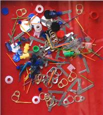 an assemblage of metal washers, buttons, pop-tops on 

a bright red background