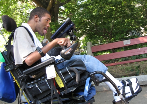 Side view of Inglis House resident driving wheelchair