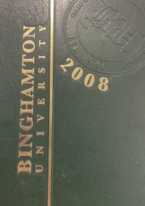 The yearbook cover is green, with gold lettering, with "2008 Binghamton University" written on the spine.