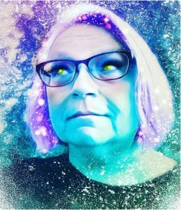 Image description/alt text: Stylized filtered selfie photograph of the author wearing glasses; they have twinkling purple hair and glowing lime green eyes, with an aura of purple and teal sparks floating around them. The author is looking skyward to the right off the screen and is slightly smirking.